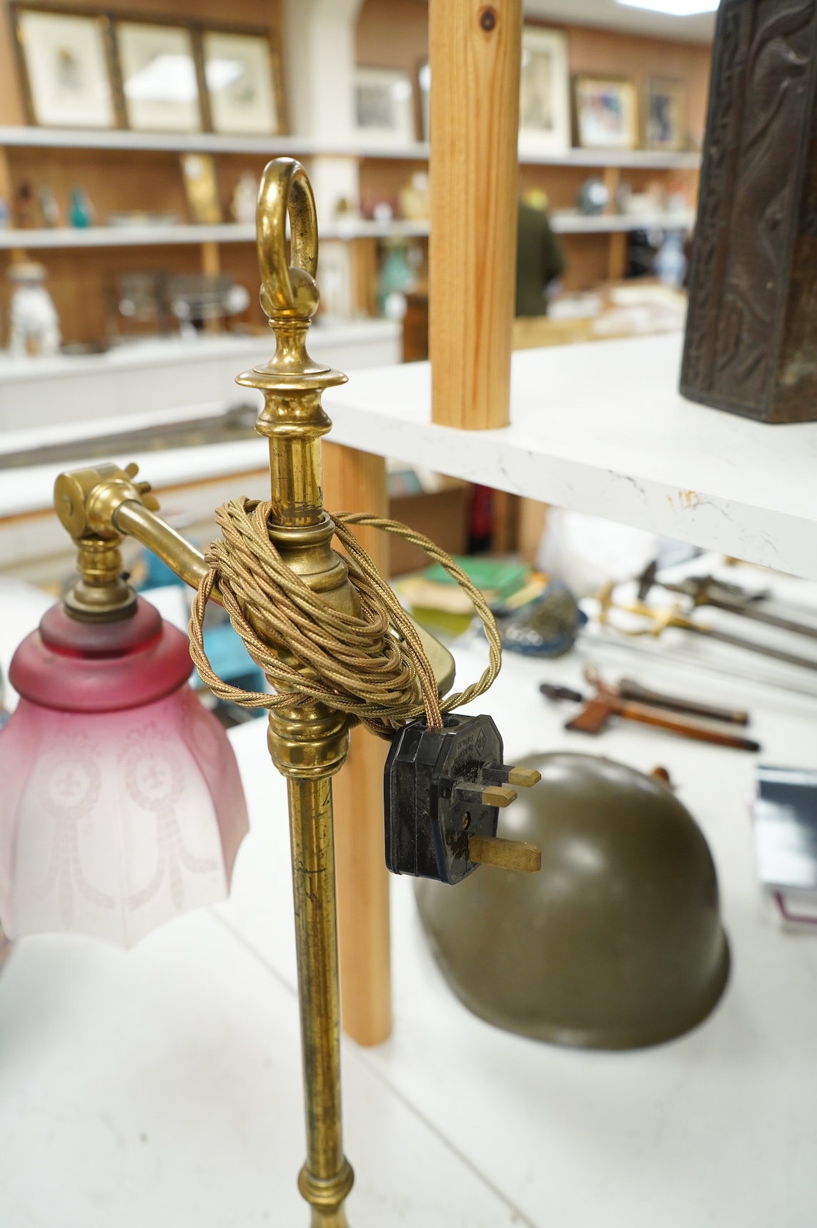 A late Victorian brass desk light with cranberry shade, 59cm